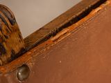 a brown piece of luggage with a glove on top of it