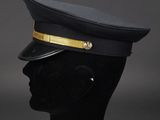 a black hat with gold trim on a mannequin head