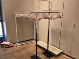 a rack with clothes hanging on it in a room