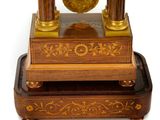 a clock that is sitting on top of a wooden stand