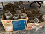 many jars sitting in a box on the floor