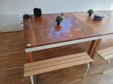 a wooden table with two benches in the middle of it