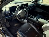 the interior of a car with the door open and the driver ' s seat down