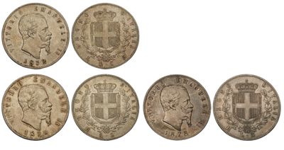 a group of five silver coins with different designs on them