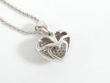 a heart shaped pendant with a bird inside of it