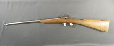 a rifle with a wooden barrel and a wooden handle