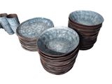 many plates and napkins stacked on top of each other