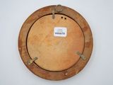 a picture of a wooden plate with a label on it