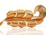 an image of a gold plated brooch with a leaf design