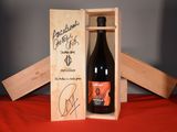 a bottle of wine in a wooden box on a table