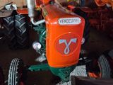 a tractor that is sitting in a room with other tractors