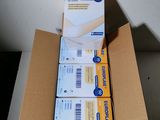 three boxes of mail sitting on top of a table next to each other