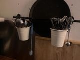 two buckets with spoons and spoons hanging on the wall