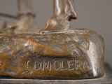 bronze statue of a man on a horse on a rock