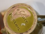 a close up of a green vase with writing on it