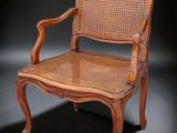 une chaise en bois avec une assise en osier sur fond noir