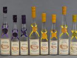 six bottles of wine are lined up in a row on a gray surface
