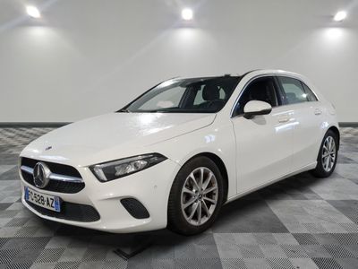 a white mercedes cla parked on a checkered floor