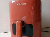 an orange air fryer sitting on a counter top