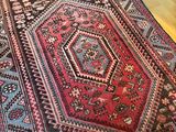 a rug on the floor in a room with a blue wall