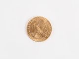 a close up of a gold coin on a white surface