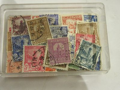 many different stamps in a plastic container on a table