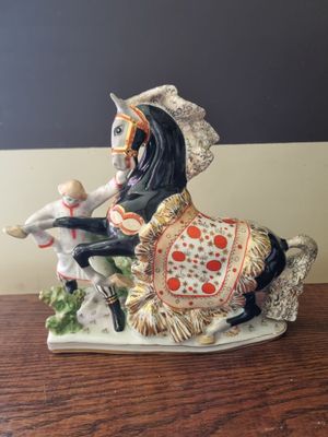 a figurine of a man riding a horse on a table