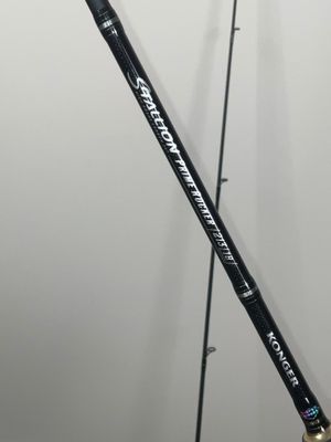 a close up of a fishing rod on a stand against a wall