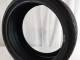 a close up of a tire on a table with a white background