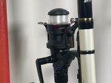 a black and white fishing rod and a red and white pole