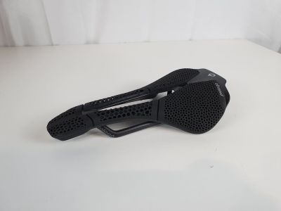 a close up of a bike seat on a white surface