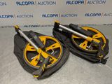 pair of yellow and black wheels for a golf cart on a table