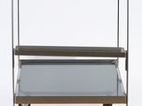 a metal and glass bar cart with two shelves on wheels