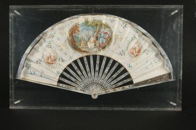 une vitrine en verre équipée d'un ventilateur et sur laquelle est accrochée une peinture