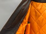 an orange and black jacket with a zipper on the back