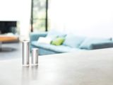 a table that has three bottles on it and a couch in the background