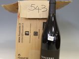 a bottle of wine sitting next to a cardboard box