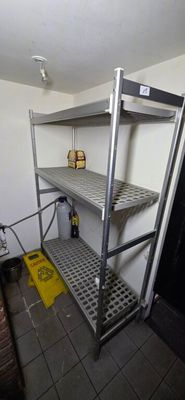 a metal shelf in the corner of a room