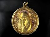 a close up of a gold medal with a woman on it