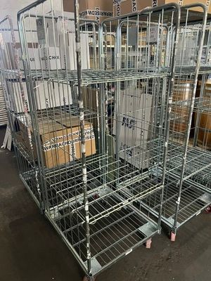a large metal cage filled with boxes in a warehouse