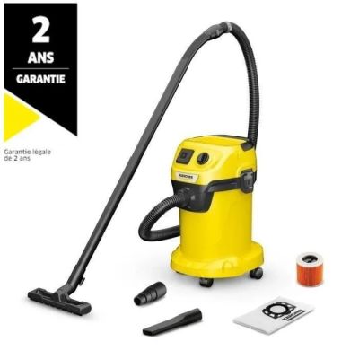 a yellow vacuum cleaner is sitting next to a spool of thread and a spool of thread