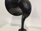 a black lamp that is on a table next to a wall