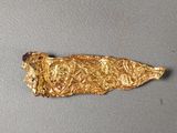 a close up of a piece of gold on a table