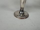 a silver candle holder with a candle inside of it