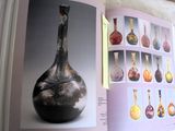 an open book with a picture of a vase on it