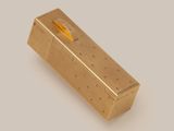 a gold box with a pencil sticking out of it