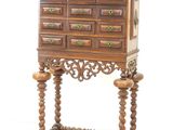 a wooden cabinet with many drawers on top of it