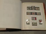 an open book with stamps on it sitting on a table
