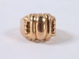 a close up of a gold ring on a white surface