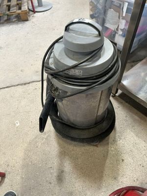 a machine that is sitting on the floor next to a pair of shoes